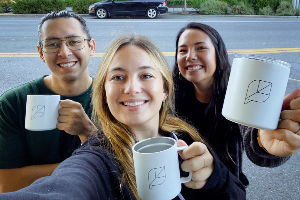 Sprout team members posing for a selfie with their custom Sprout coffee mugs.